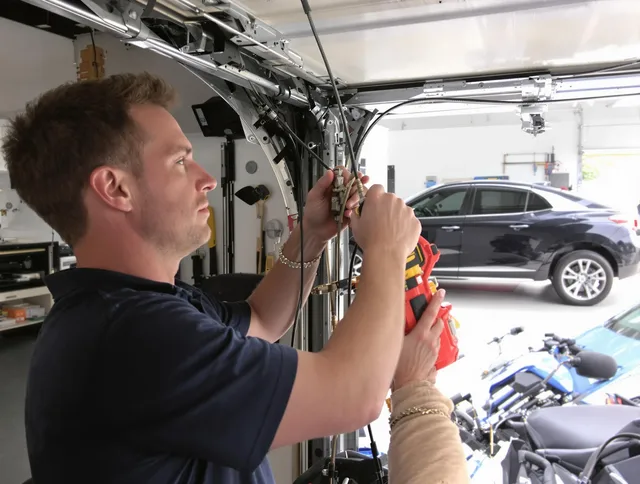 Stafford Garage Door Repair safety certified technician performing cable replacement in Stafford