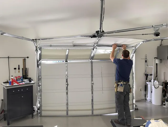 Stafford Garage Door Repair specialist performing precise section replacement on Stafford garage door